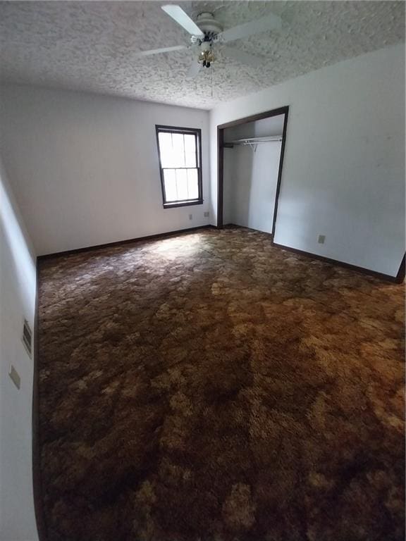 6005 Hendrix Rd, Cumming, GA 30040 - unfurnished bedroom featuring carpet flooring, a closet, a ceiling fan, and a textured ceiling