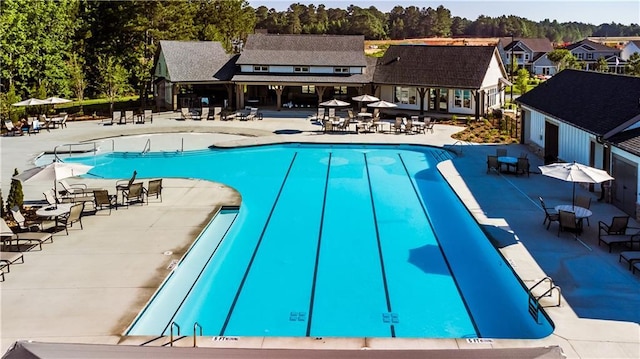 112 Kerr Dr, Hoschton, GA 30548 - community pool with a patio, a residential view, and view of wooded area