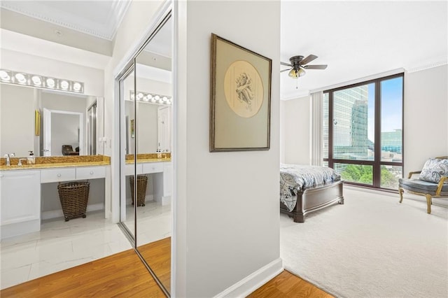 3475 Oak Valley Rd NE Unit 950, Atlanta, GA 30326 - bedroom with ornamental molding, a sink, baseboards, and ensuite bath