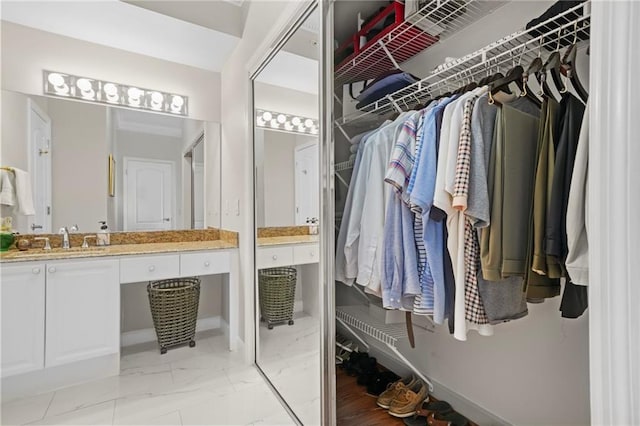 3475 Oak Valley Rd NE Unit 950, Atlanta, GA 30326 - walk in closet featuring light marble finish flooring and a sink
