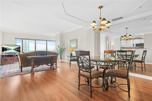 3475 Oak Valley Rd NE Unit 950, Atlanta, GA 30326 - dining room with a chandelier, ornamental molding, baseboards, and light wood-style floors