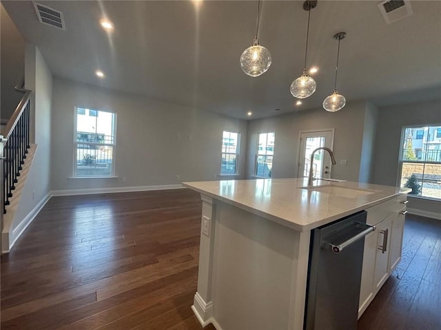 kitchen featuring dark wood-style flooring, a sink, visible vents, open floor plan, and stainless steel dishwasher