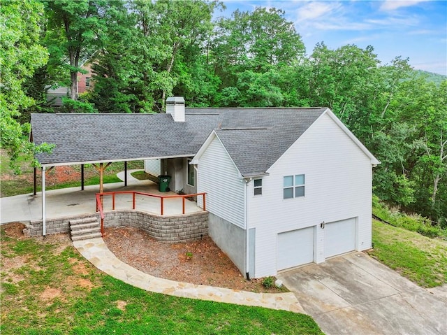 205 Crooked Pine Trl, Baldwin, GA 30511 - rear view of house with roof with shingles, a garage, a chimney, and driveway