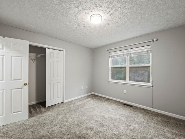 205 Crooked Pine Trl, Baldwin, GA 30511 - unfurnished bedroom featuring carpet flooring, a closet, a textured ceiling, and baseboards