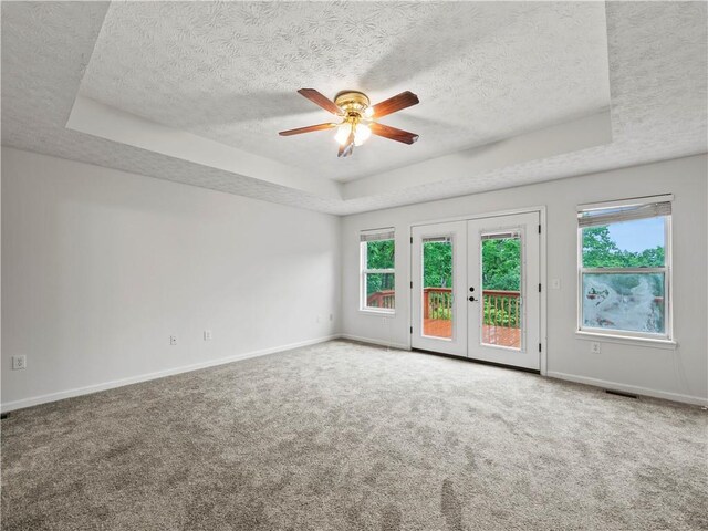 205 Crooked Pine Trl, Baldwin, GA 30511 - spare room with a raised ceiling, a textured ceiling, a ceiling fan, carpet flooring, and baseboards