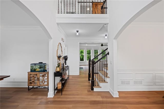 602 Davenport Pl, Canton, GA 30115 - foyer entrance with a ceiling fan, ornamental molding, wood finished floors, a high ceiling, and arched walkways