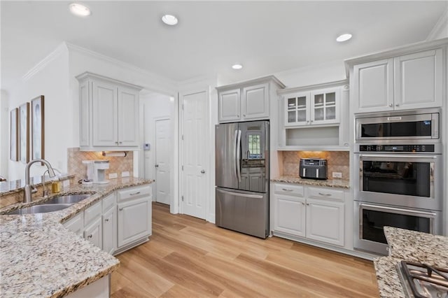 602 Davenport Pl, Canton, GA 30115 - kitchen with stainless steel appliances, a sink, ornamental molding, decorative backsplash, and white cabinets