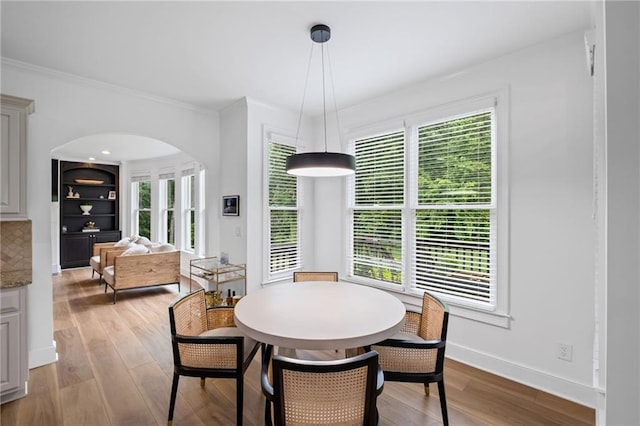 602 Davenport Pl, Canton, GA 30115 - dining area with arched walkways, plenty of natural light, light wood-style flooring, and ornamental molding