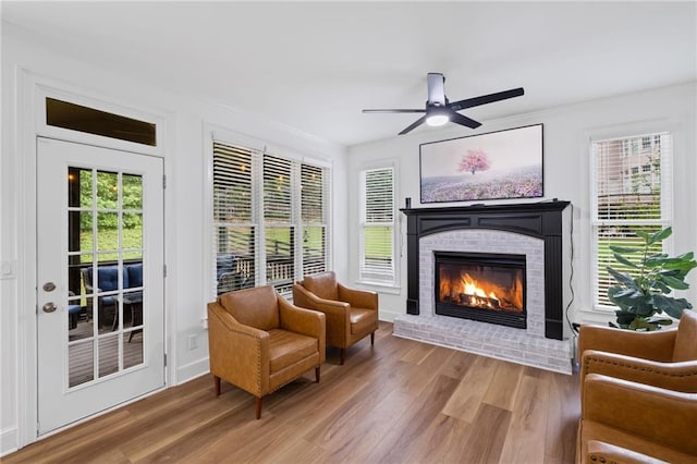 602 Davenport Pl, Canton, GA 30115 - sitting room featuring wood finished floors, a brick fireplace, and a ceiling fan