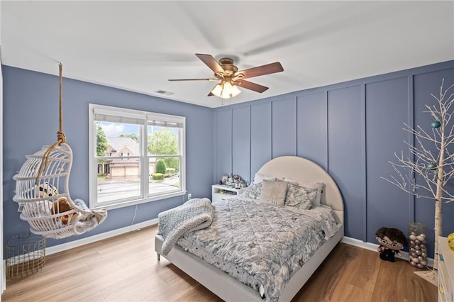602 Davenport Pl, Canton, GA 30115 - bedroom featuring wood finished floors, a decorative wall, ceiling fan, and baseboards
