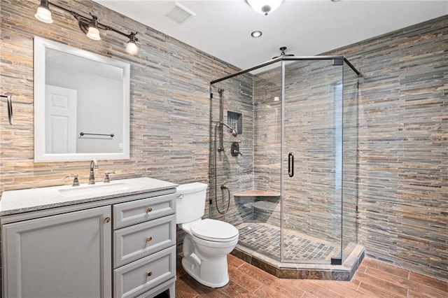 602 Davenport Pl, Canton, GA 30115 - full bathroom featuring tile walls, toilet, vanity, a shower stall, and wood tiled floors
