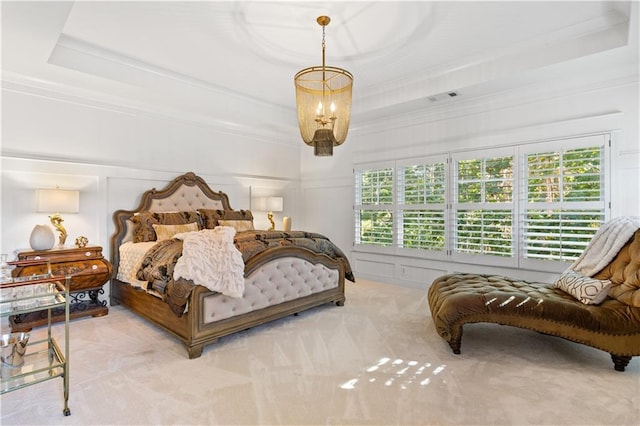 carpeted bedroom featuring ornamental molding, a raised ceiling, and a chandelier