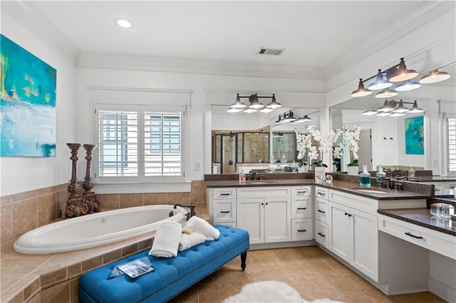 bathroom featuring vanity, crown molding, and separate shower and tub