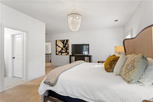 bedroom featuring light colored carpet and a chandelier