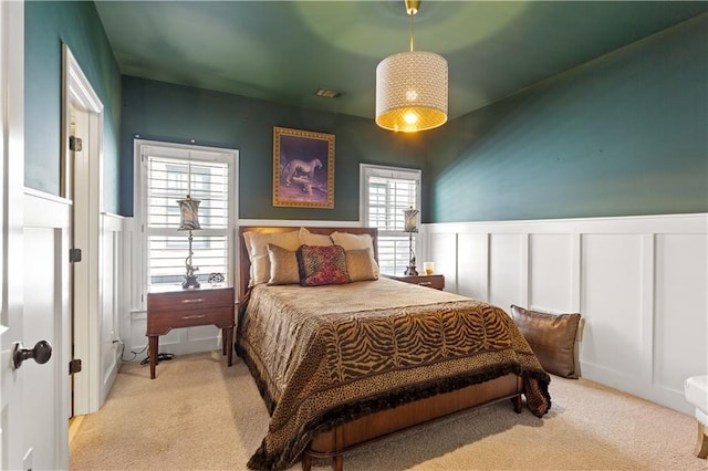 bedroom featuring light colored carpet