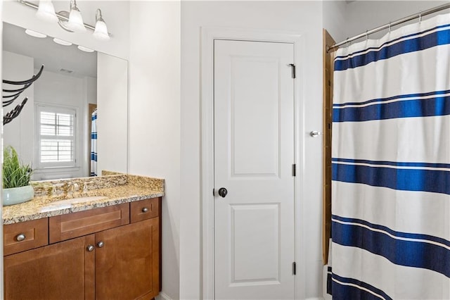 bathroom featuring vanity and curtained shower