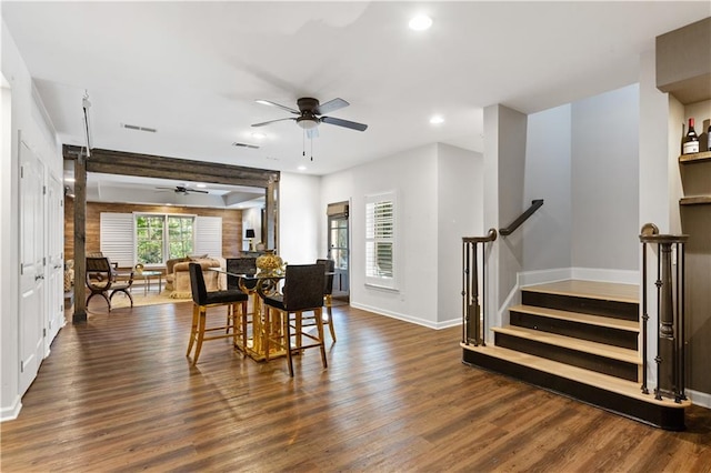 dining area featuring dark wood-type flooring and ceiling fan