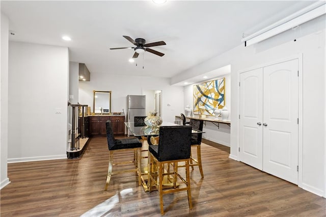 dining area with dark hardwood / wood-style floors and ceiling fan