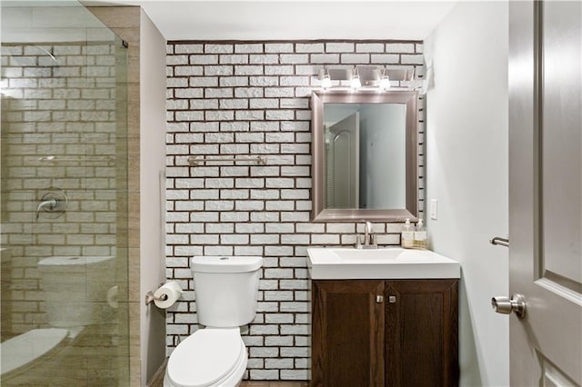 bathroom with vanity, tasteful backsplash, toilet, and walk in shower