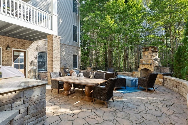 view of patio / terrace with an outdoor stone fireplace