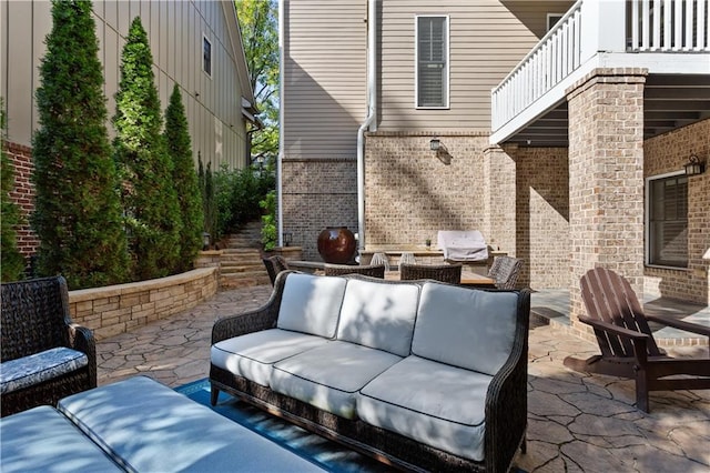 view of patio with an outdoor living space, a balcony, and grilling area