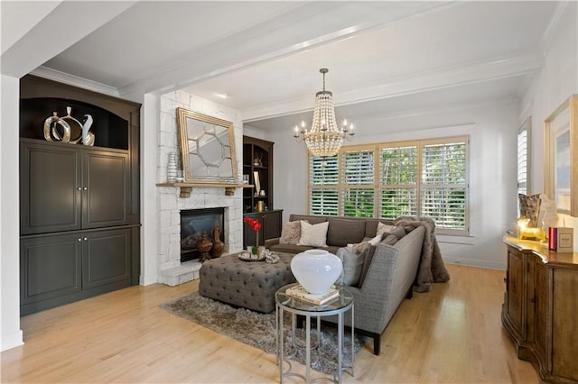 living room featuring beam ceiling, crown molding, a fireplace, and light hardwood / wood-style floors