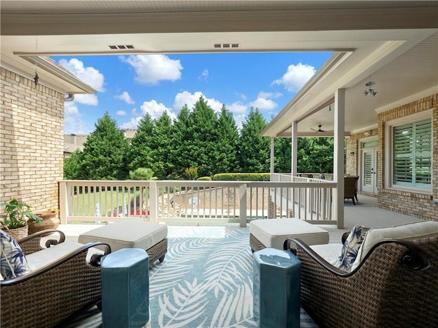 view of patio / terrace featuring an outdoor living space, a ceiling fan, and covered porch