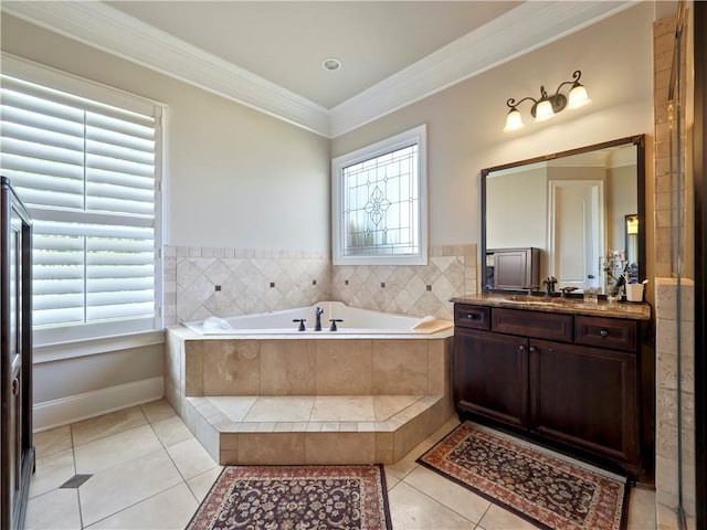 bathroom with tile patterned flooring, ornamental molding, a garden tub, and vanity