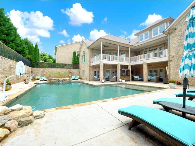 view of pool with ceiling fan, an outdoor living space, a fenced in pool, a fenced backyard, and a patio