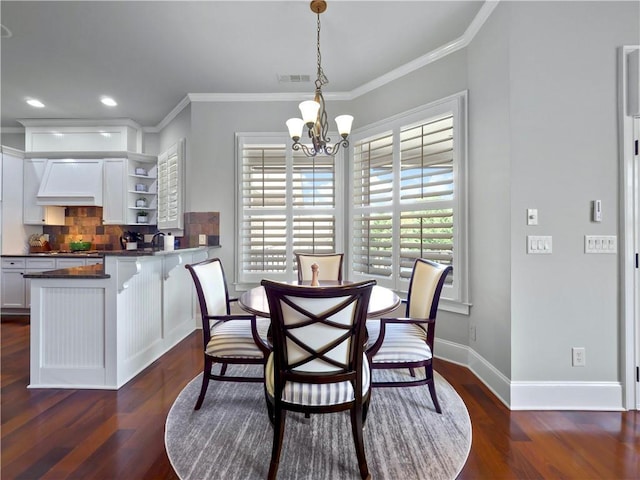 dining space featuring a chandelier, baseboards, dark wood-type flooring, visible vents, and ornamental molding