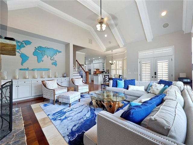 living area featuring visible vents, dark wood finished floors, stairway, high vaulted ceiling, and beamed ceiling