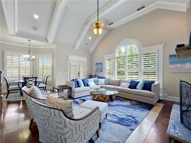 living room with visible vents, baseboards, ceiling fan with notable chandelier, and high vaulted ceiling