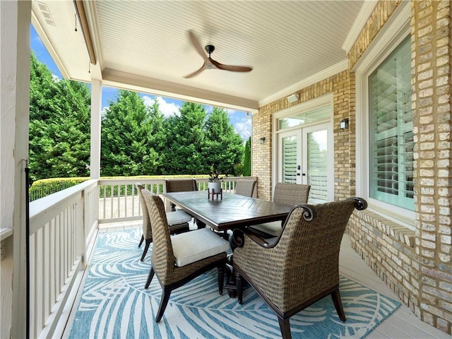 wooden deck with french doors, a ceiling fan, and outdoor dining area