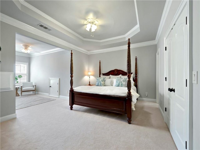 bedroom featuring baseboards, light carpet, a tray ceiling, and visible vents