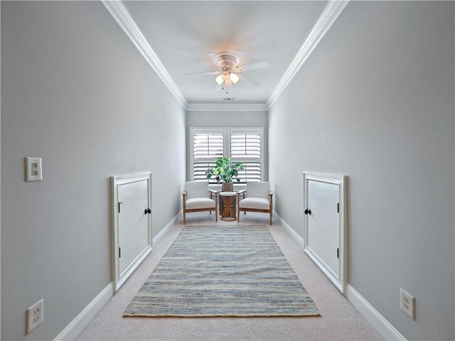 living area with baseboards, ceiling fan, ornamental molding, and light carpet