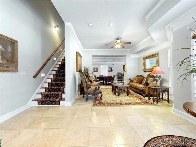 living area with crown molding, stairs, baseboards, ceiling fan, and light tile patterned floors