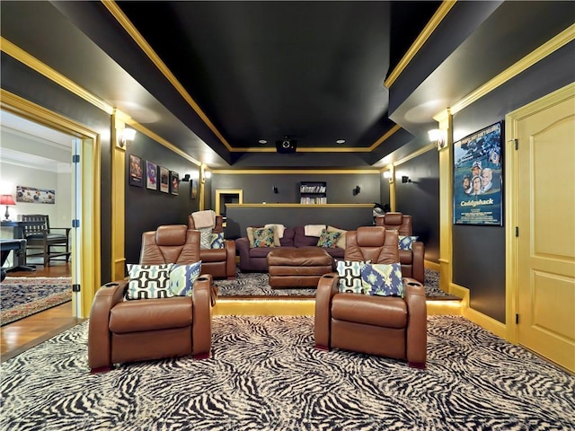 home theater with crown molding, baseboards, wood finished floors, and a raised ceiling