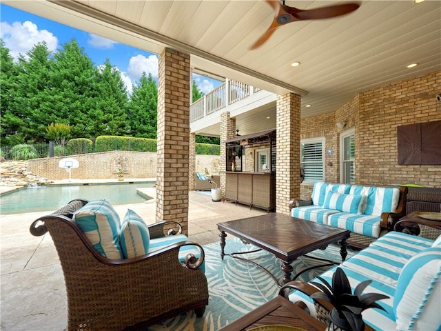 view of patio / terrace featuring ceiling fan, a fenced in pool, a balcony, a fenced backyard, and outdoor lounge area