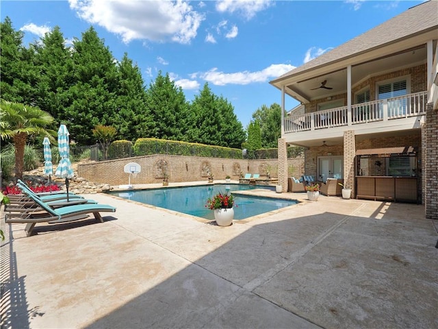 view of pool with ceiling fan, a patio area, fence, a fenced in pool, and outdoor lounge area