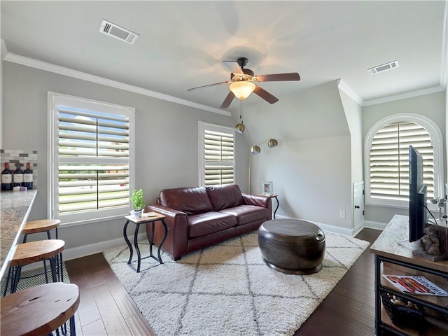 living area with baseboards, a ceiling fan, and visible vents