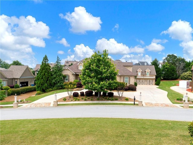 view of front of home featuring a garage, a residential view, a front yard, and concrete driveway