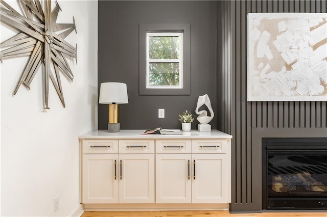 interior space featuring a glass covered fireplace