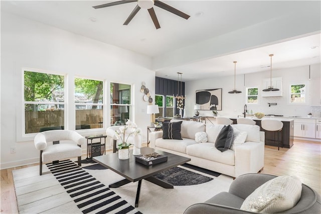 living room featuring ceiling fan and light wood-style floors