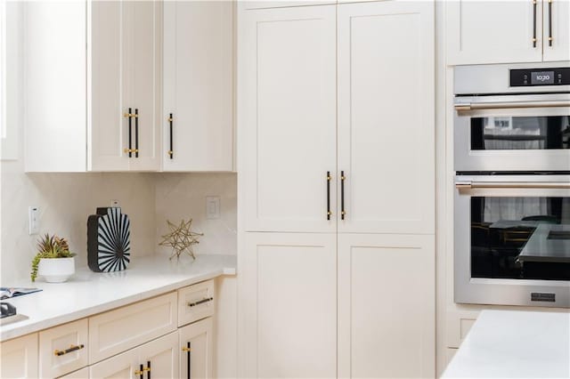 interior space with light countertops, white cabinetry, and double oven
