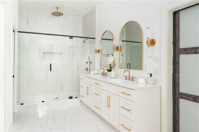 bathroom featuring a marble finish shower, a sink, marble finish floor, and double vanity