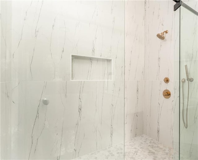 bathroom with a marble finish shower