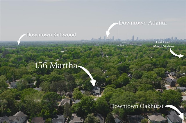 drone / aerial view featuring a wooded view