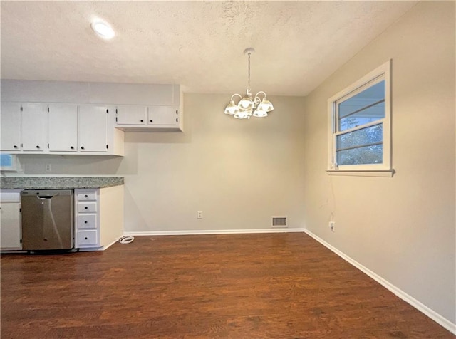 kitchen with pendant lighting, stainless steel dishwasher, white cabinetry, and dark wood-type flooring