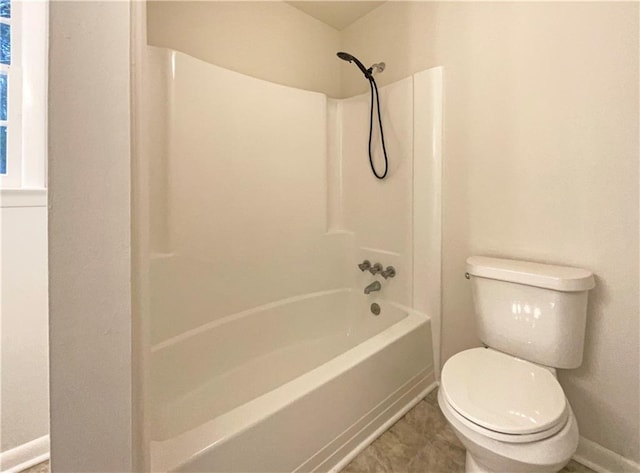 bathroom with bathtub / shower combination and toilet