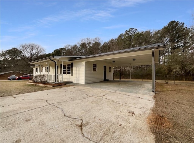 single story home featuring a porch and a carport